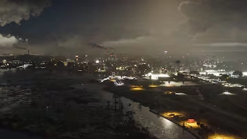 Industrial plants and refinery lights dominate the rural GTA 6 region of Ambrosia at night.