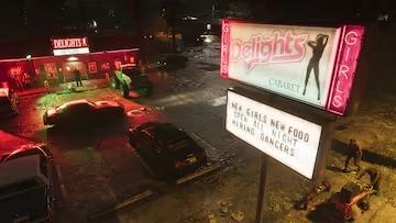 A neon-lit cabaret and parked cars at night in the declining coastal town of GTA 6 Port Gellhorn.